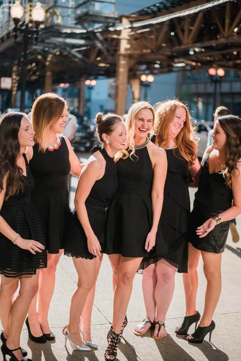 Six female friends on a bachelorette trip laughing together in Chicago, USA