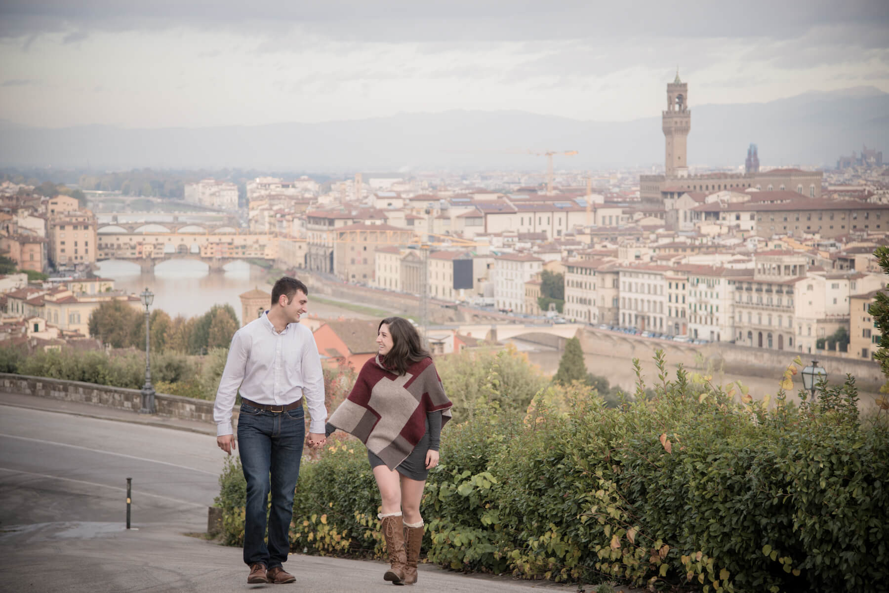 Couple holding hands walking uphill in Florence, Italy