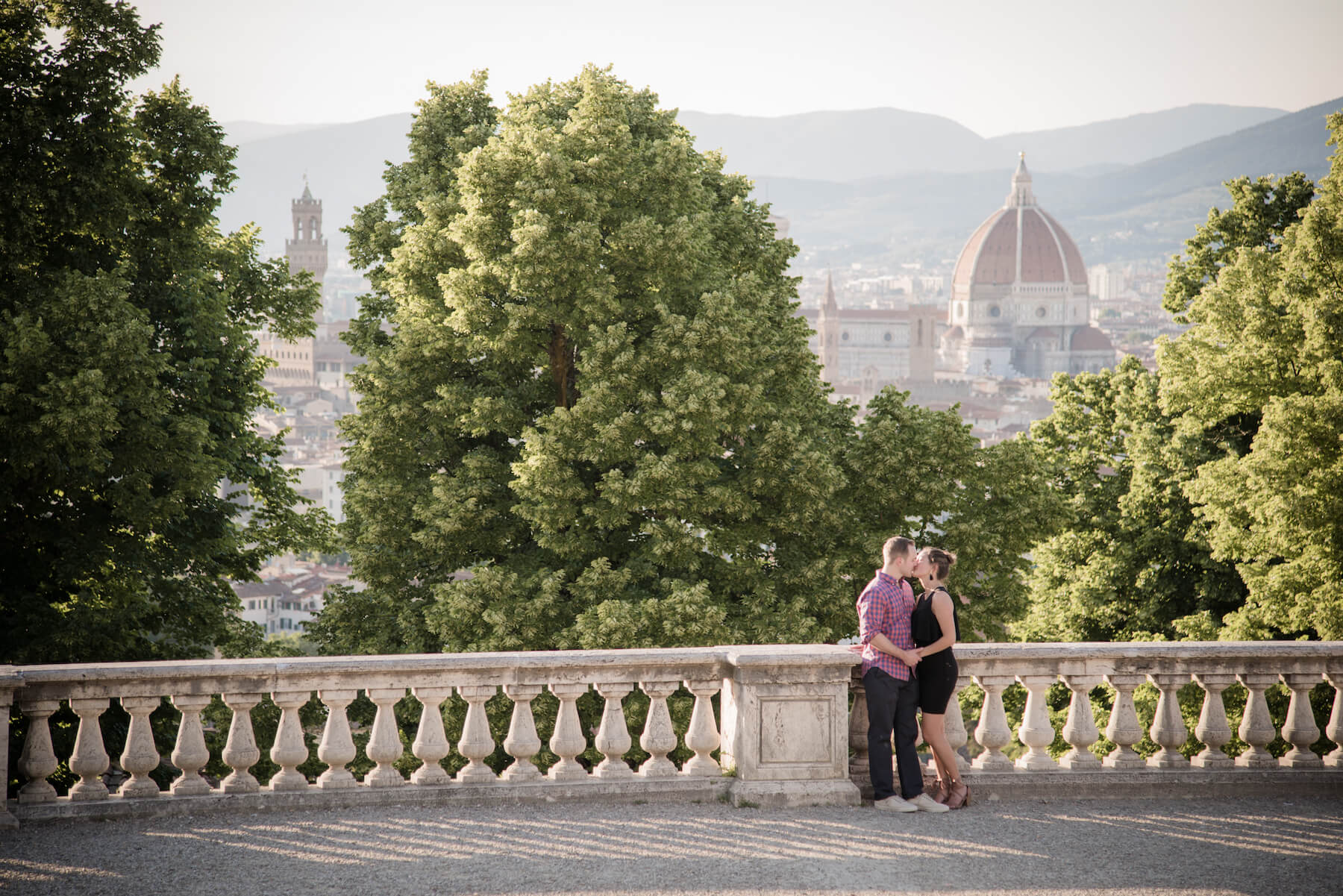 Couple kissing with the city of Florence, Italy in the background