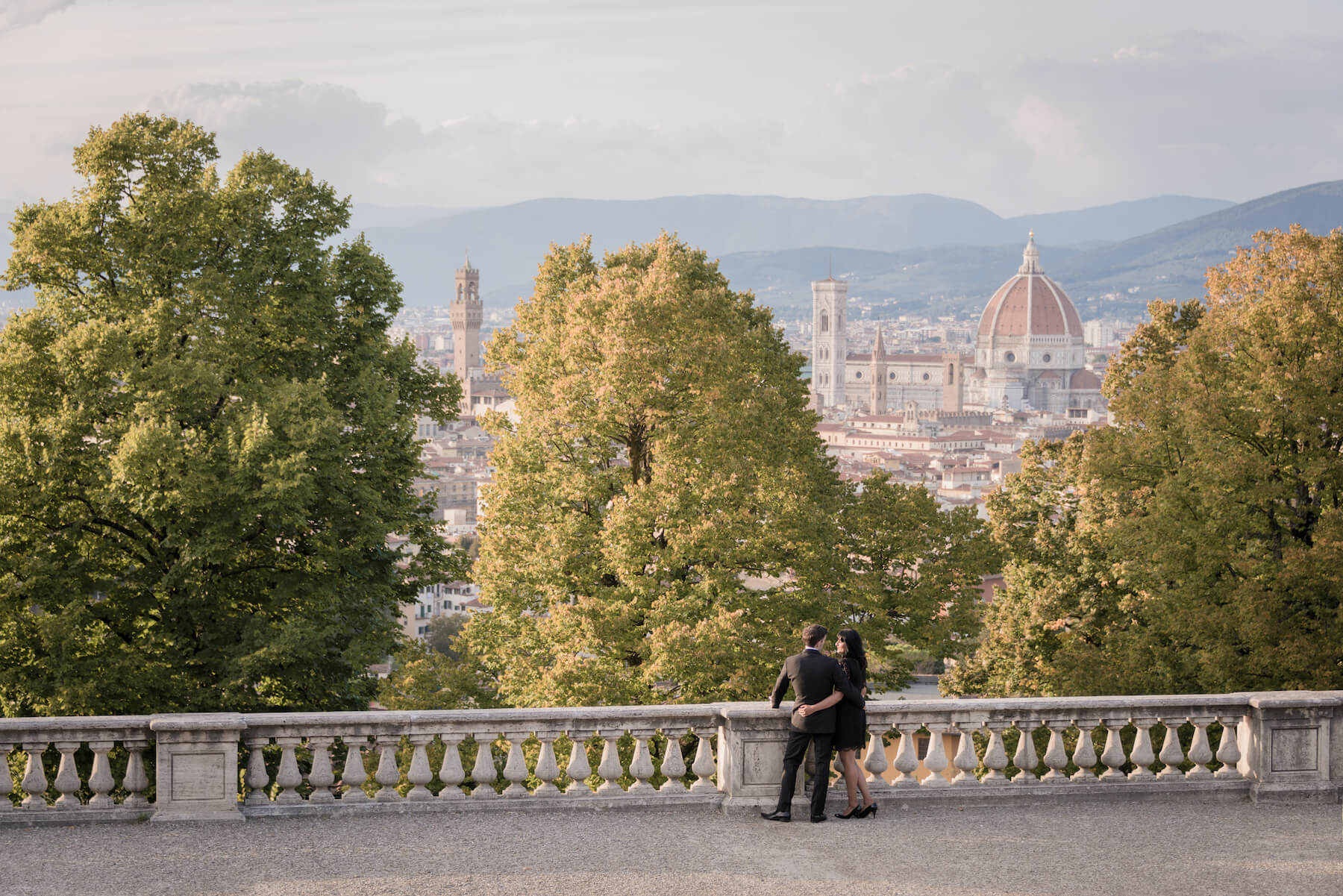 Couple hugging and looking over the city of Florence, Italy