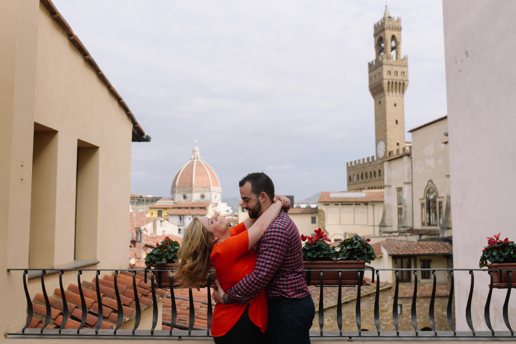 Couple sitting together on steps in small alley in Florence, Italy