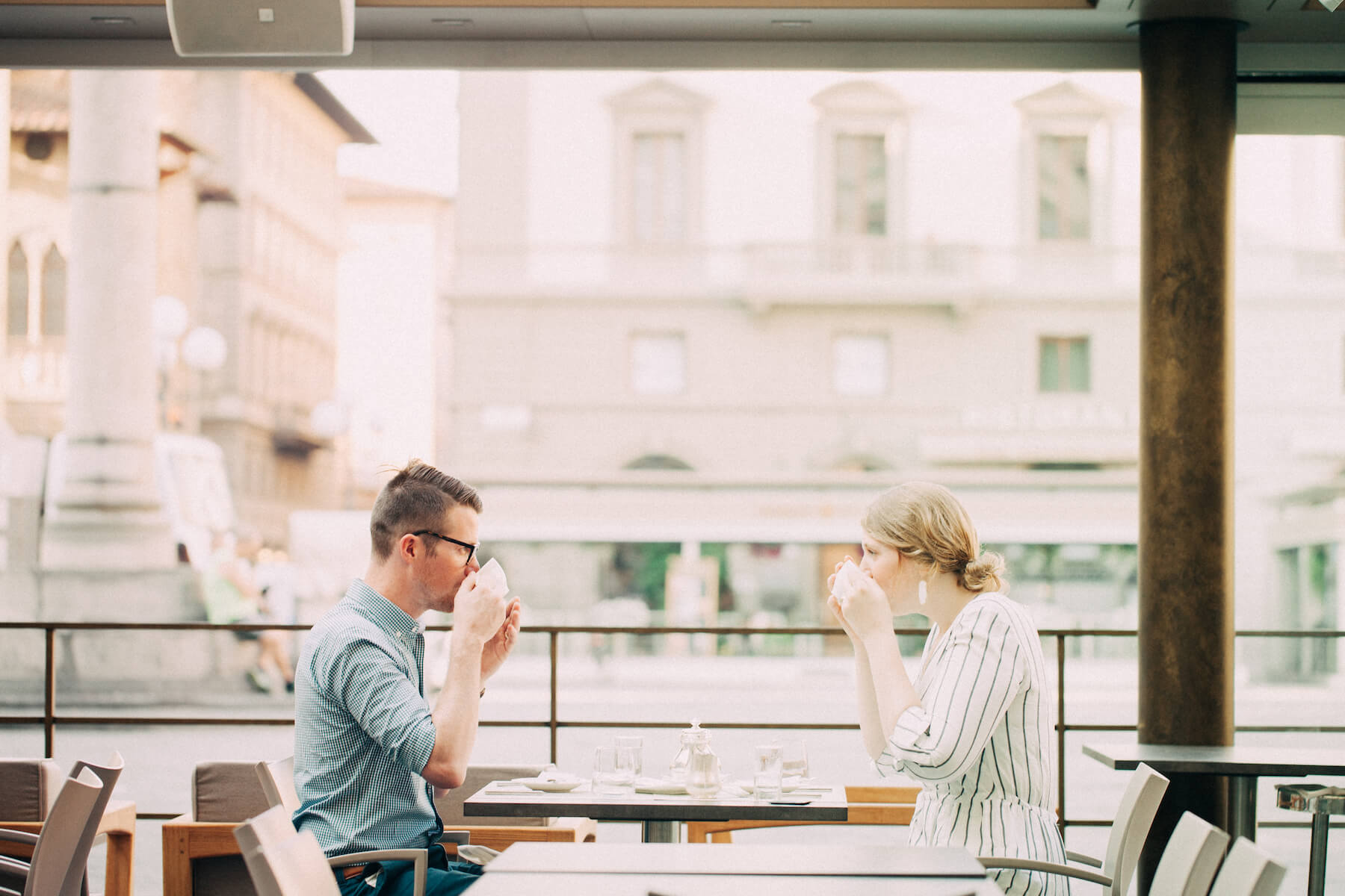 Couple drinking coffee together at a cafe in Florence, Italy