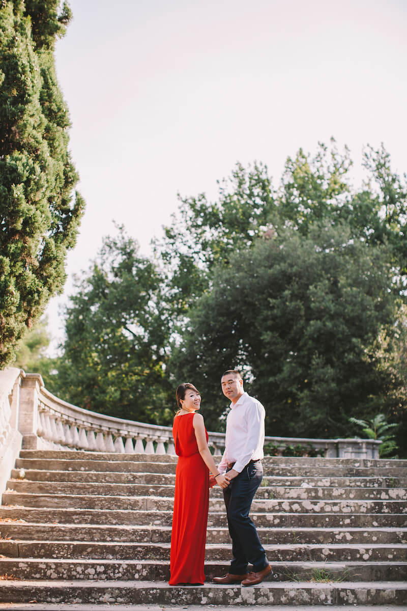 Asian couple standing on steps together in Florence, Italy