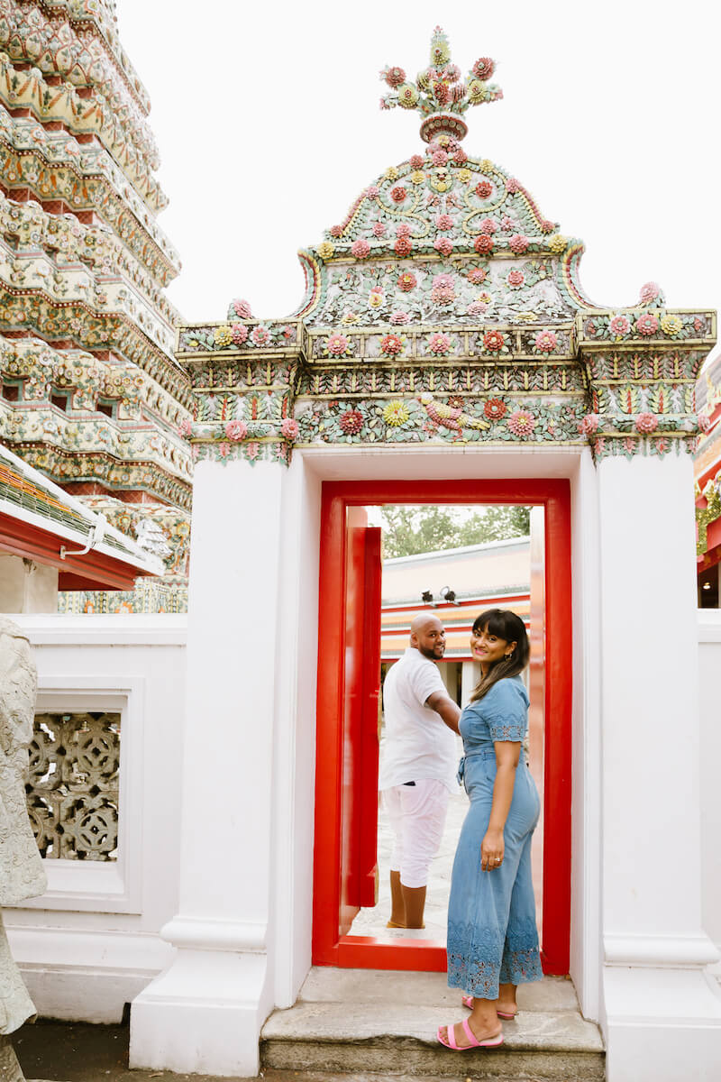 Couple entering the Grand Palace temple in Bangkok, Thailand