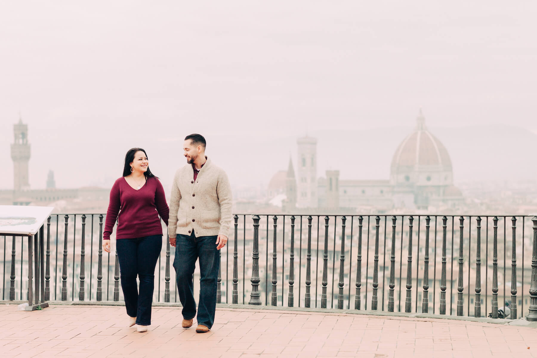 Couple looking lovingly at each other on a trip together at Piazzale Michelangelo in Florence, Italy