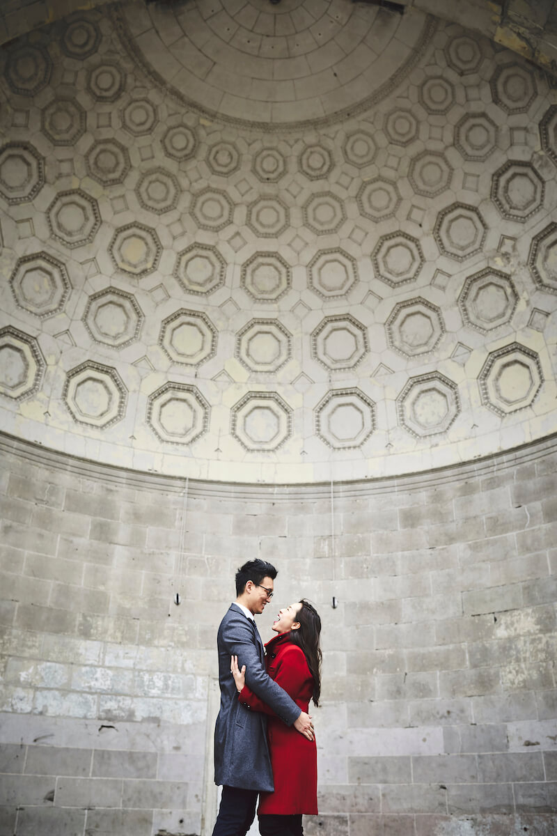 Asian couple hugging and smiling at each other in Central Park, New York City, USA