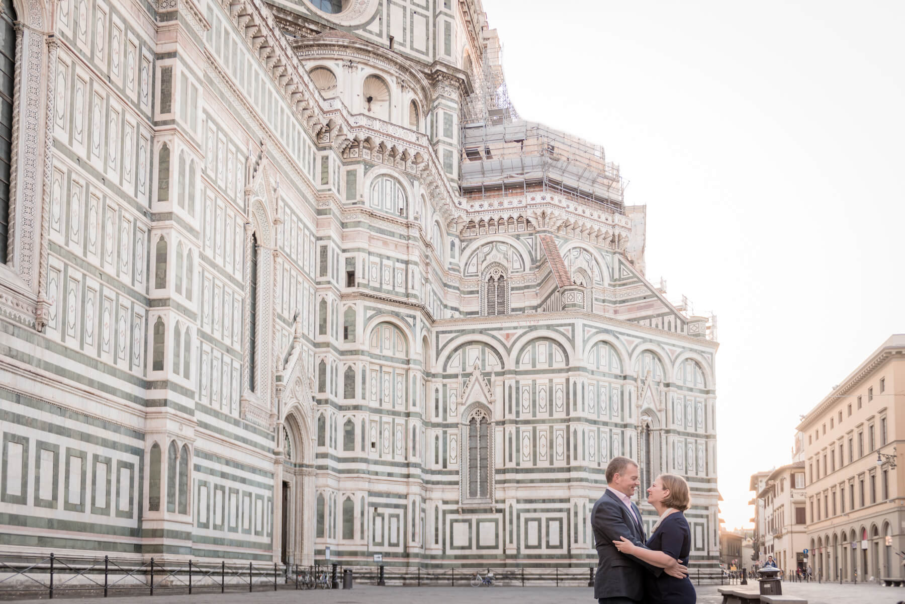 Mature couple hugging each other in front of The Duomo on a couples trip in Florence, Italy