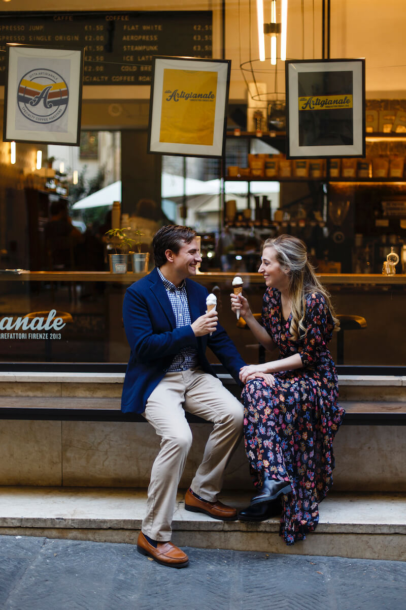 Couple sitting together in front of Ditta Artigianale gelato shop on couples trip in Florence, Italy