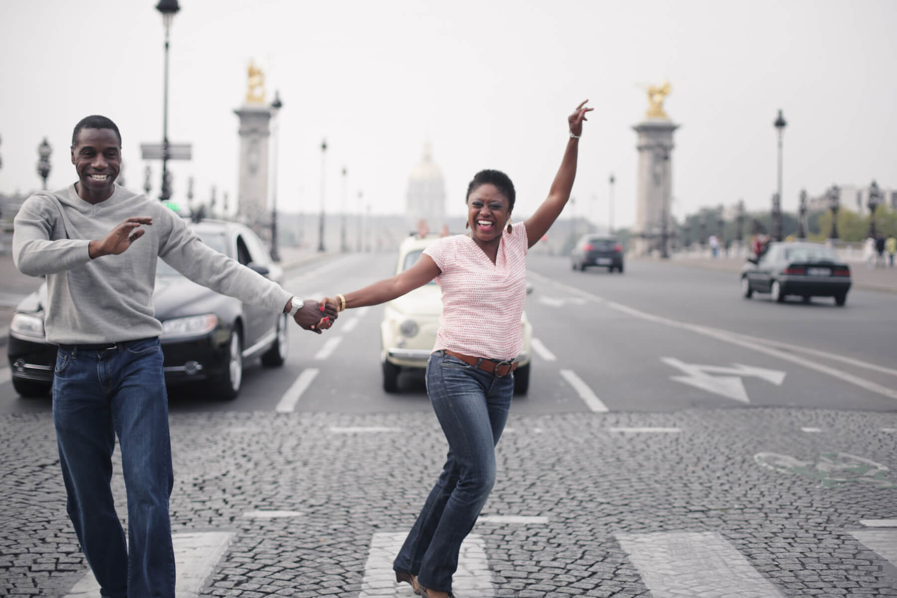 Couple dancing together in an intersection in Paris, France