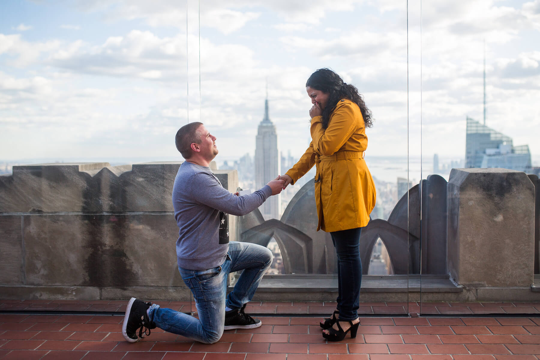 Man proposing to his partner as his partner is crying happy tears in New York City, New York USA