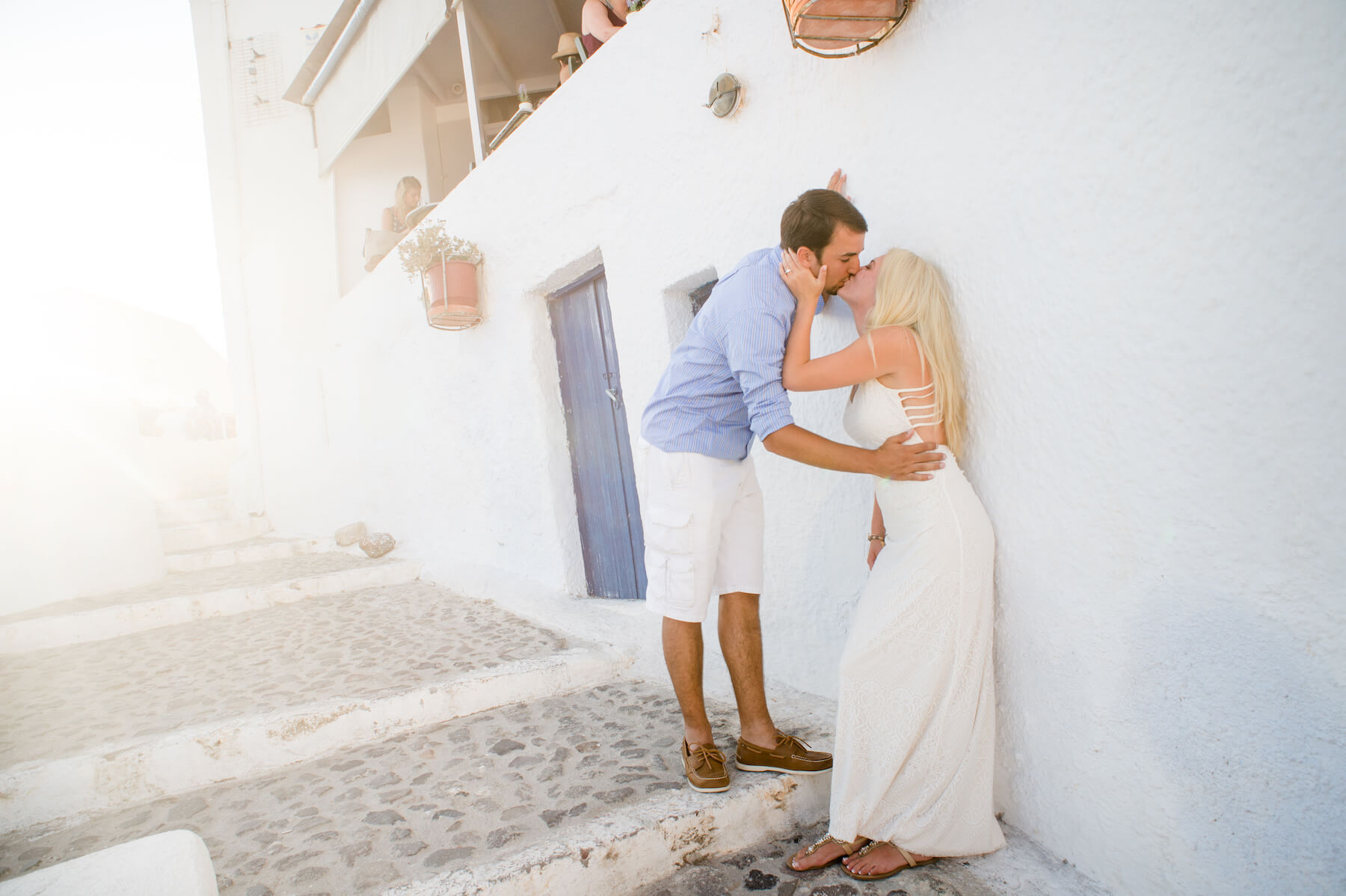 Couple kissing each other on a couples trip in Santorini, Greece