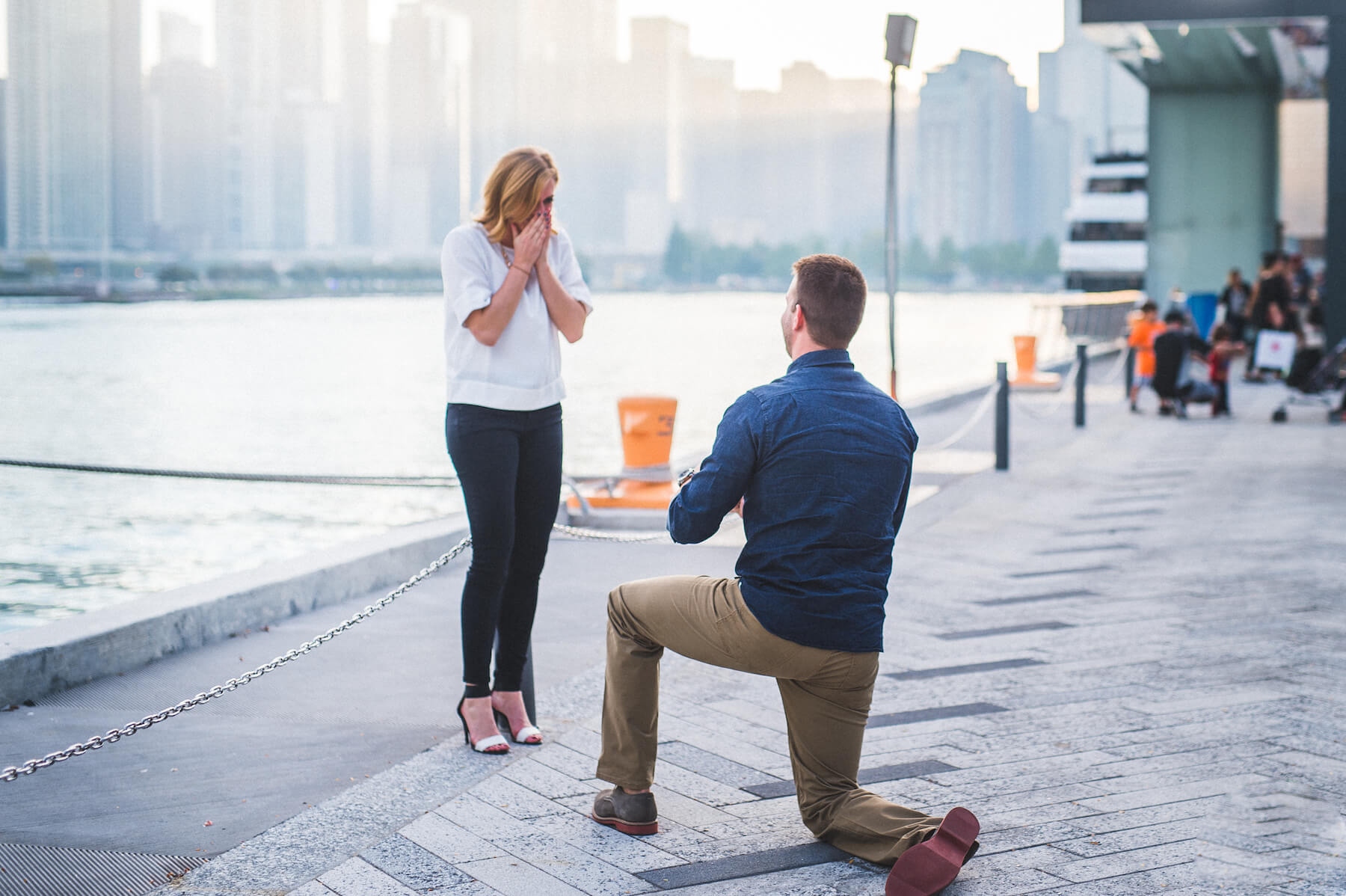 Woman surprised at surprise Flytographer proposal while her partner presents her engagement ring in Chicago, USA