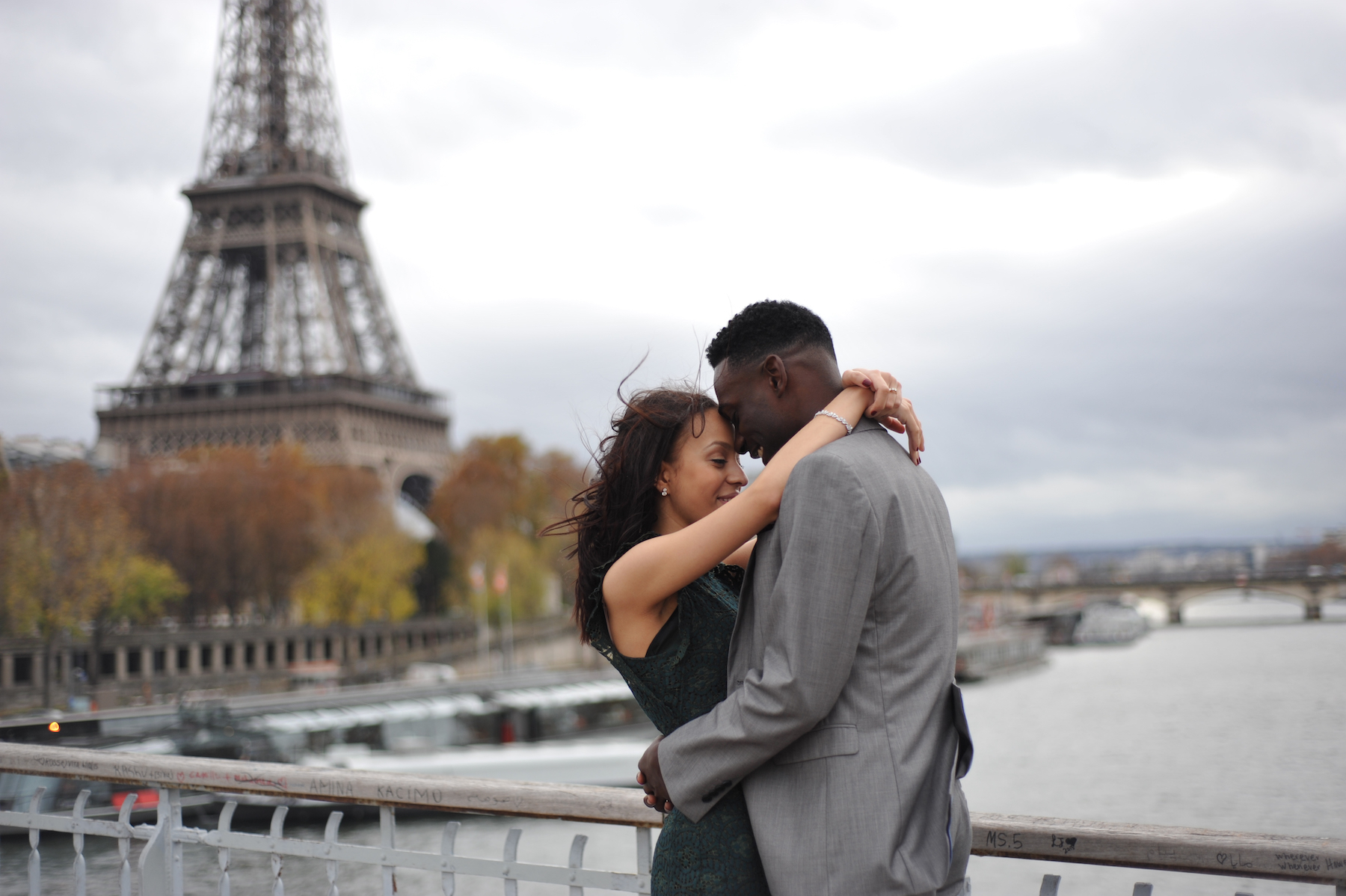 Couple hugging each other with the Eiffel Tower in the background in Paris, France