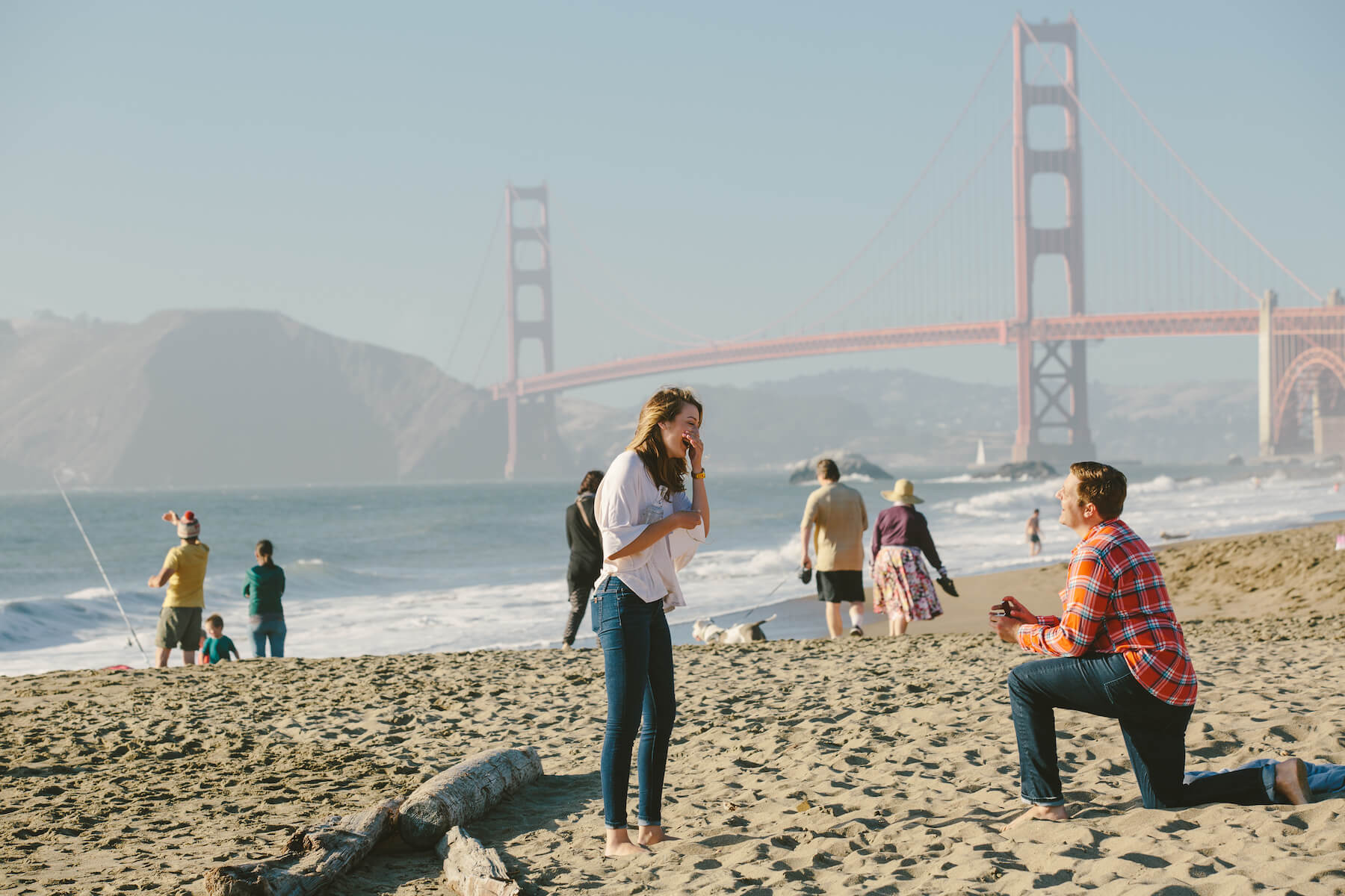 Man proposing to his partner on a beach in San Francisco, California, USA