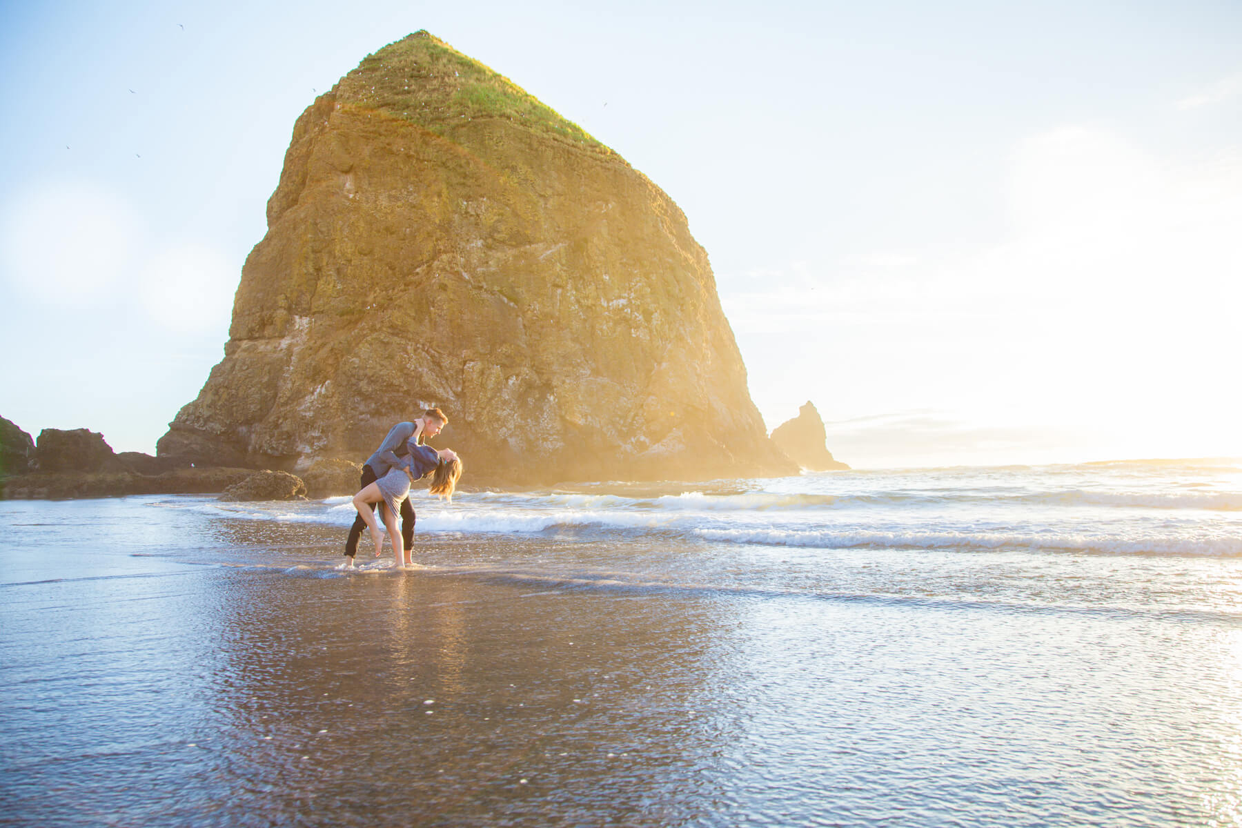 Couple dancing together in the water at Cannon Beach in Portland, Oregon USA