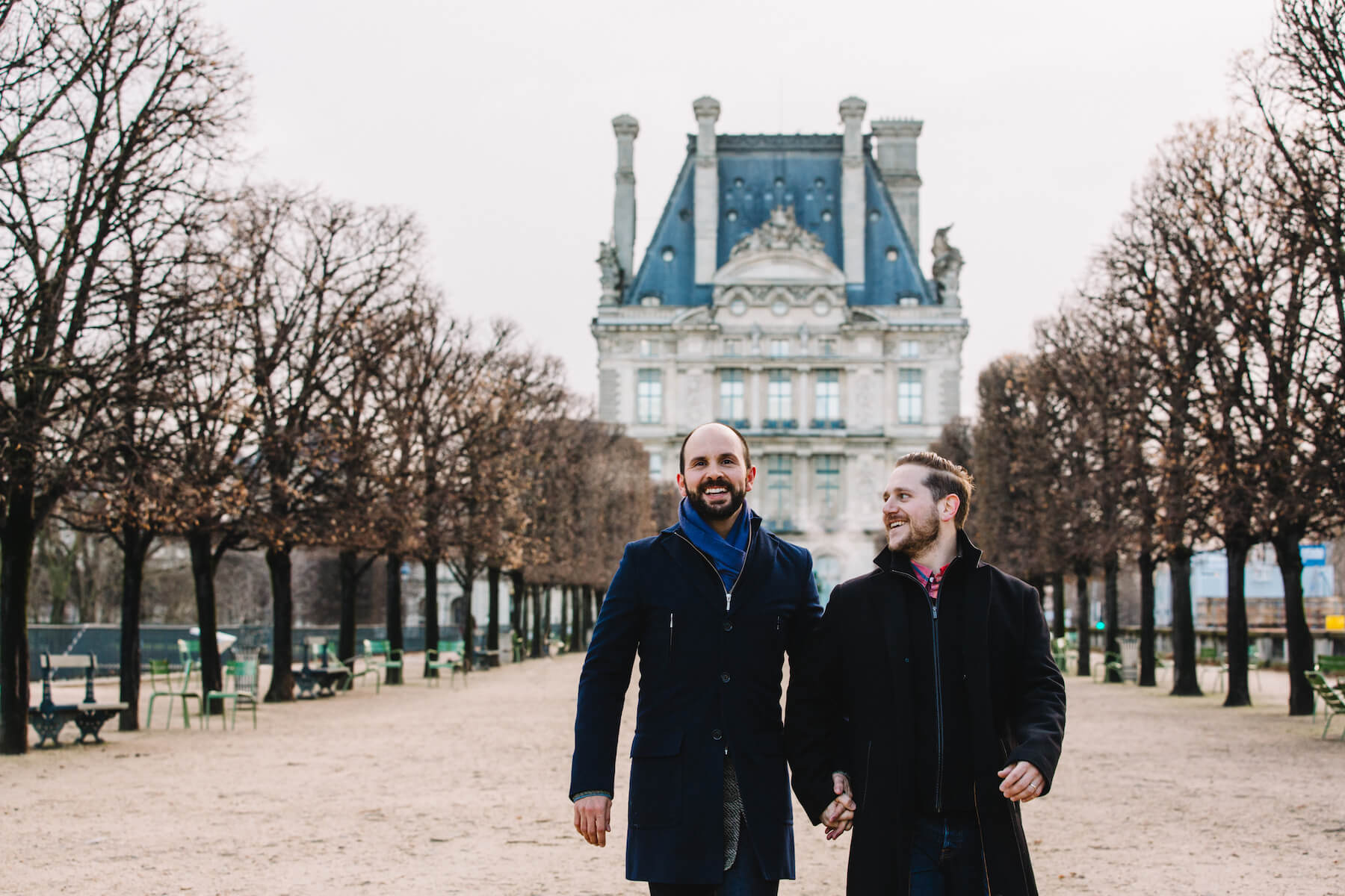 LGBTQ+ couple holding hands and walking together in Paris, France
