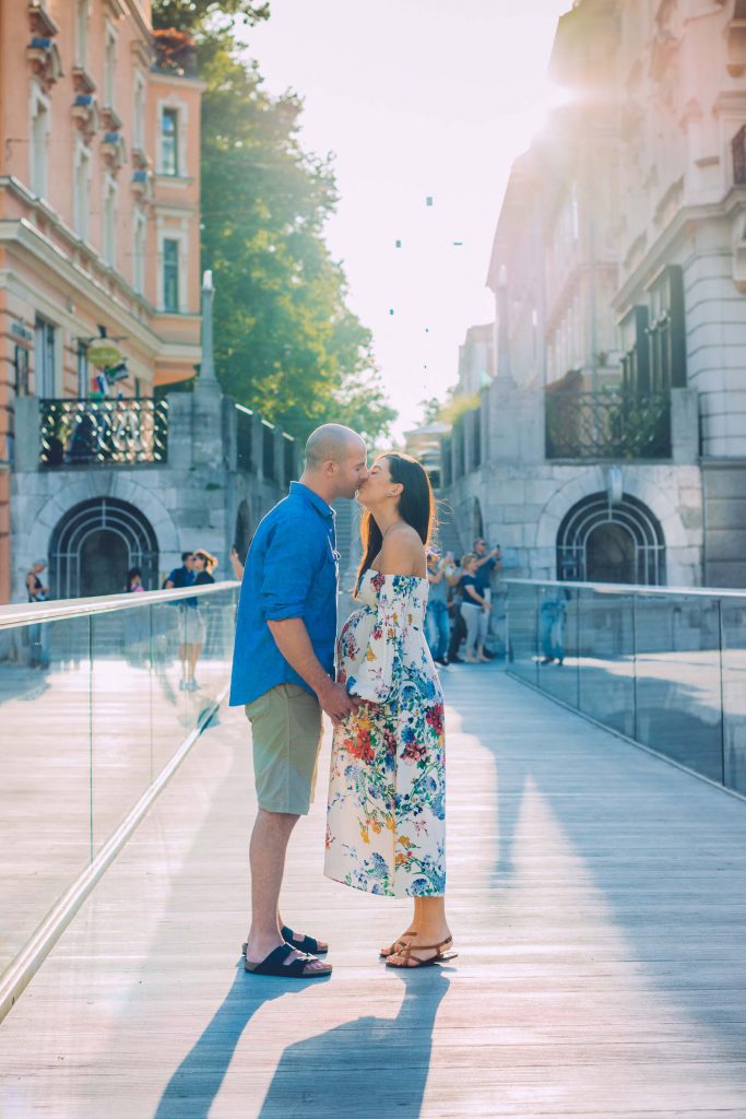 A couple kisses on a bridge in Ljubljana