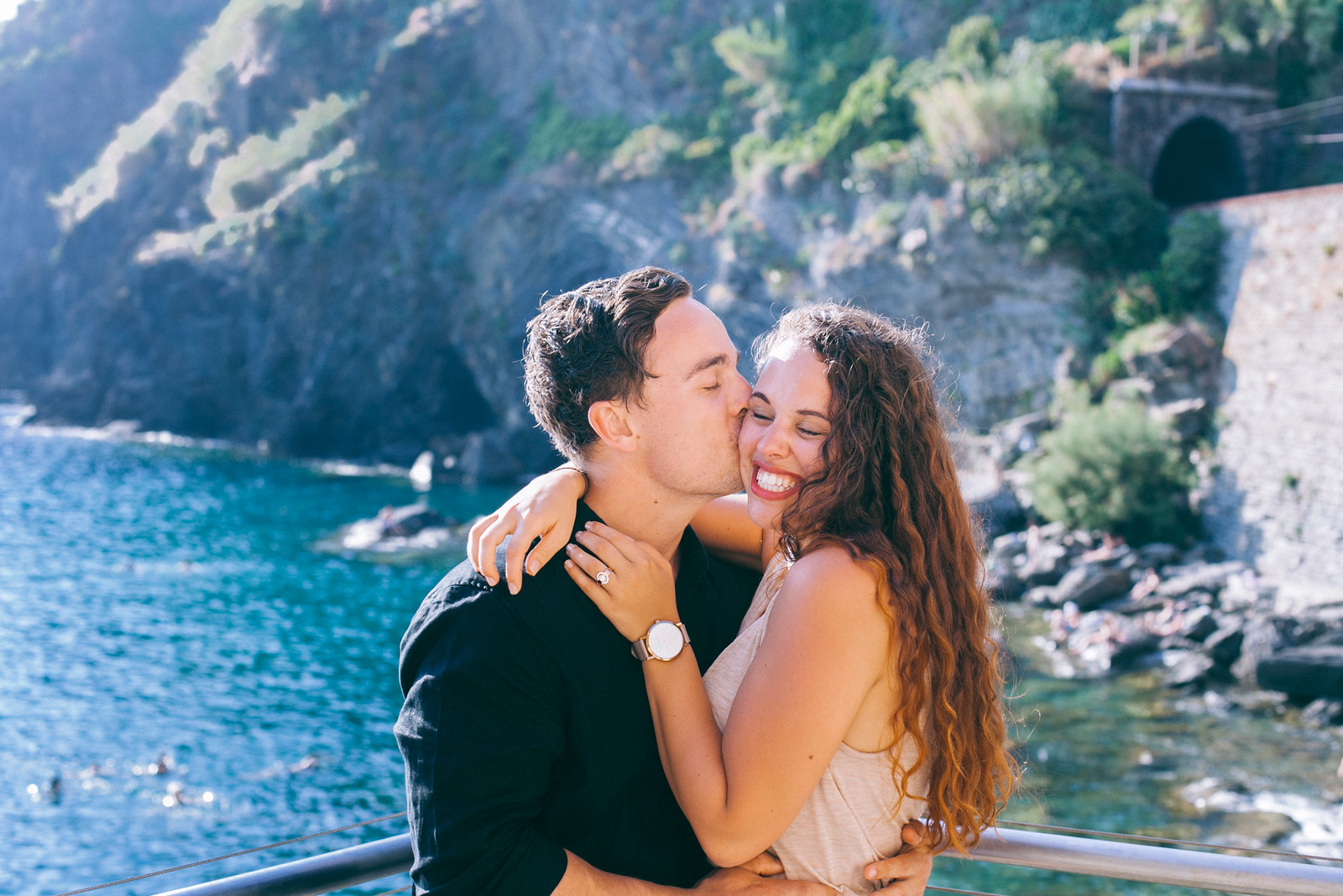 Man kissing his partner's cheek in Cinque Terre, Italy