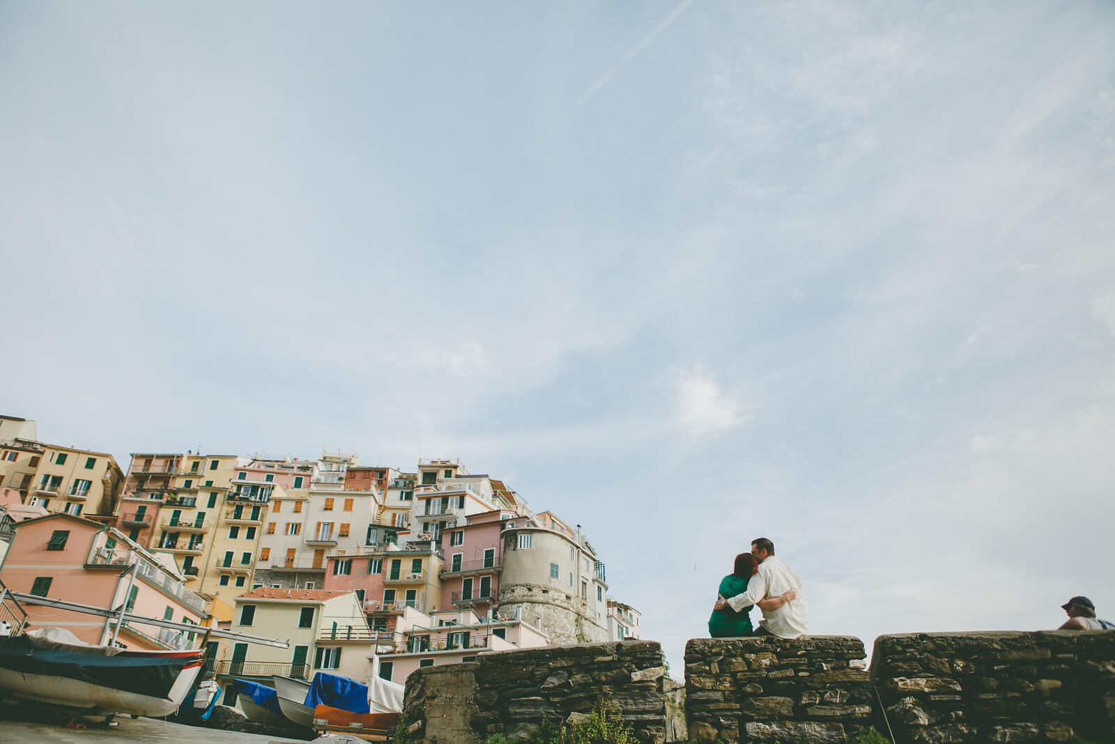 Man kissing his partner's forehead in Cinque Terre, Italy
