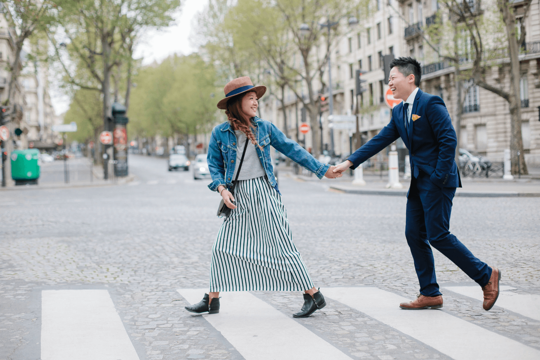 Couple crossing the street on a couples trip in Paris, France