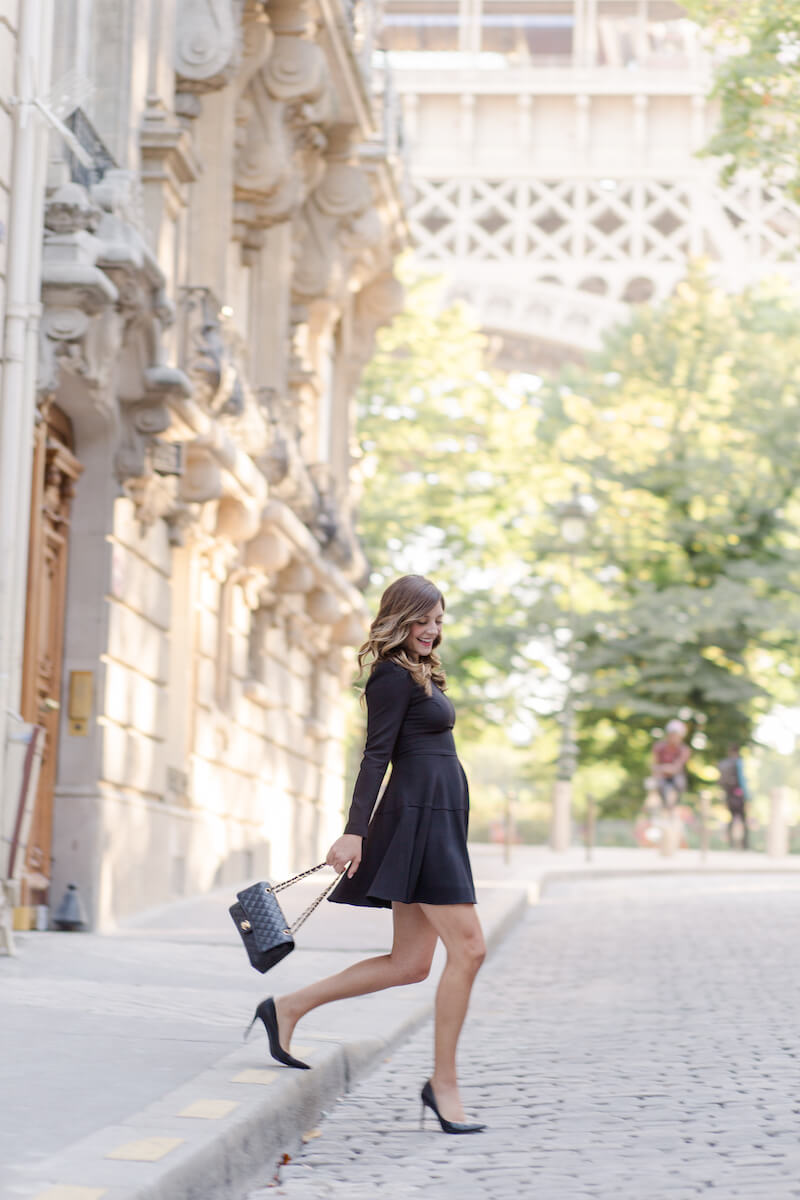 solo traveller wearing a black form fitting dress in Paris, France