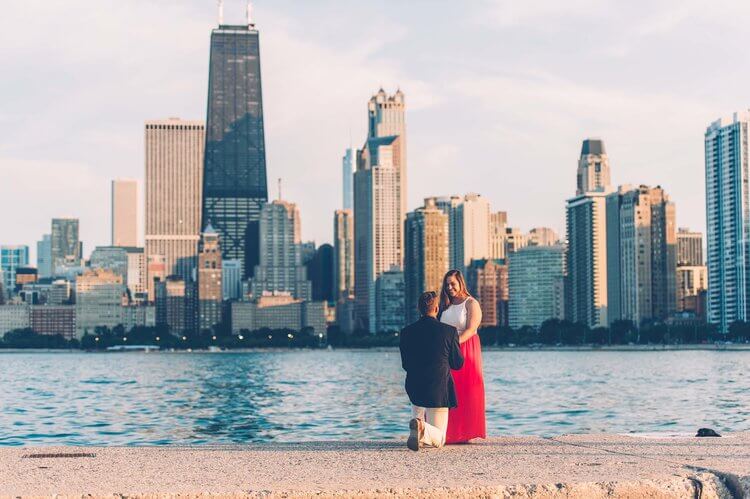 Man proposing to his partner with downtown Chicago in the background