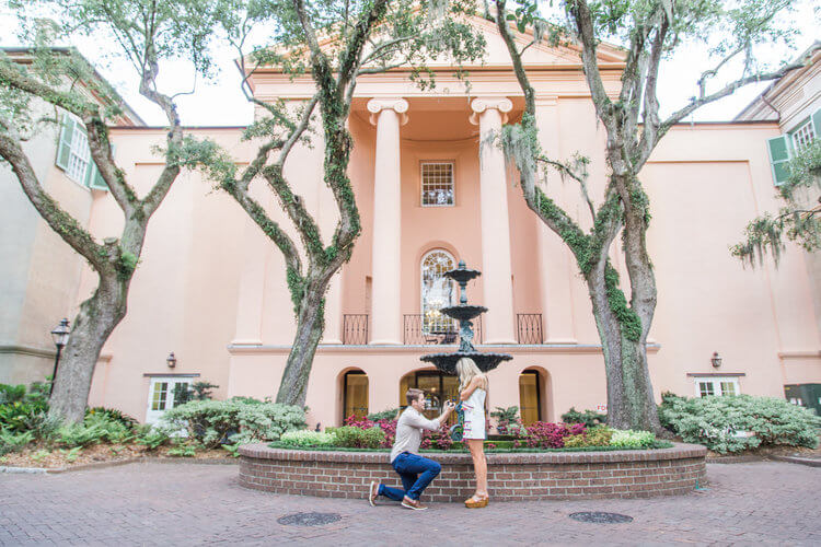 Woman shocked by her partner's surprise proposal at the College of Charleston Fountain in Philadelphia, USA