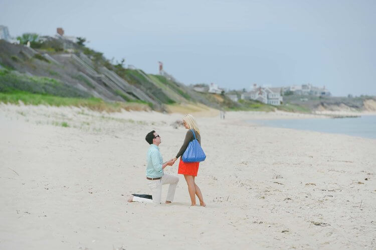 Man proposing to his partner on the beach in Nantucket, USA