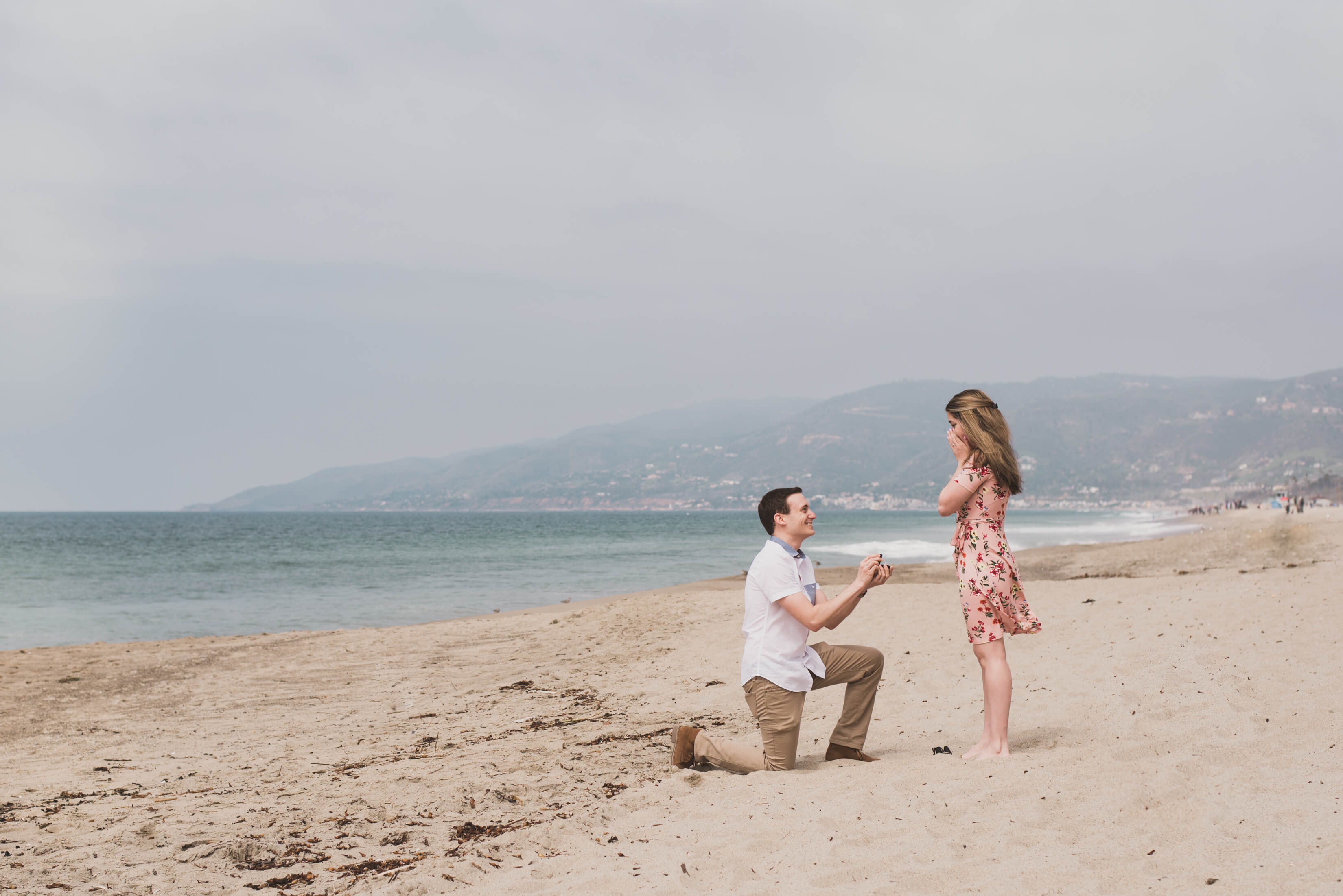 Man proposing to his partner at a beach in Los Angeles, California USA