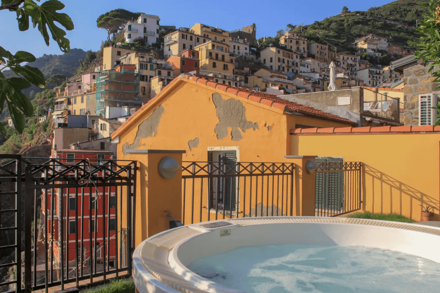 an image of a hot tub on an airbnb balcony overlooking Cinque Terre, Italy