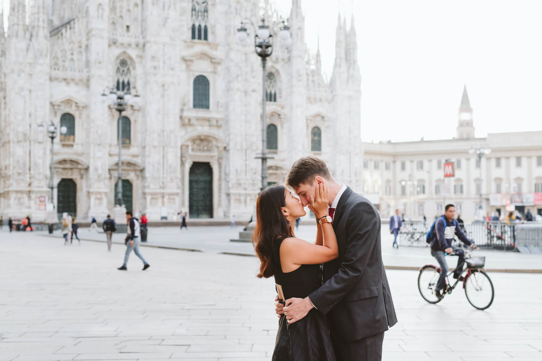 couple holding each other in front of Duomo di Milano, Milan, Italy