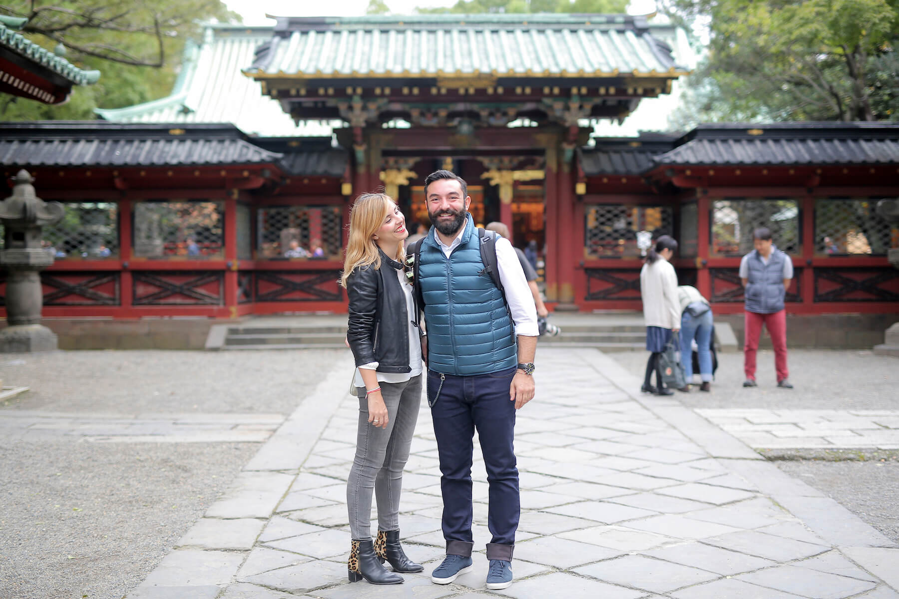 Couple standing in front of a temple in Tokyo, Japan