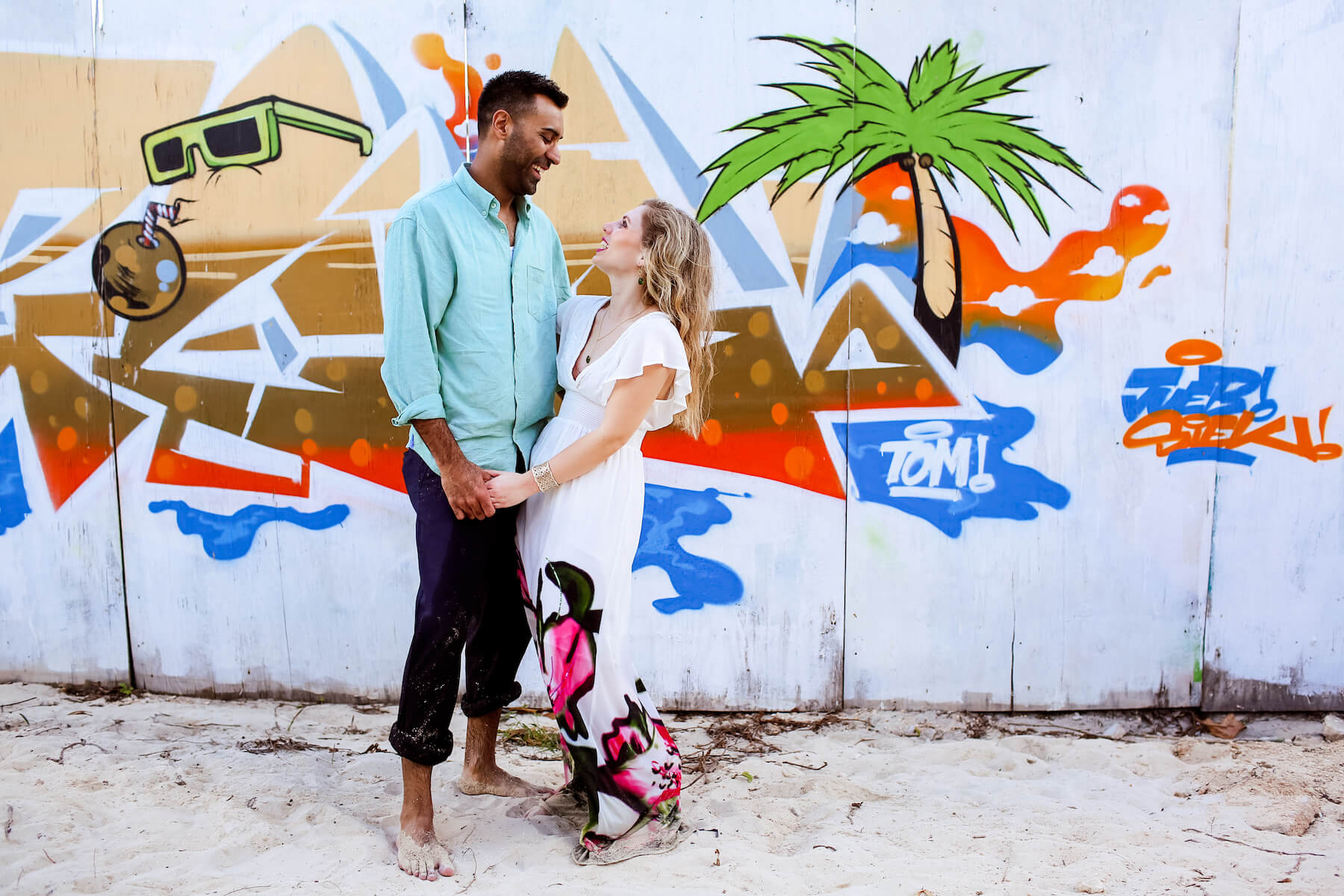 Couple laughing and holding hands in Playa del Carmen, Mexico