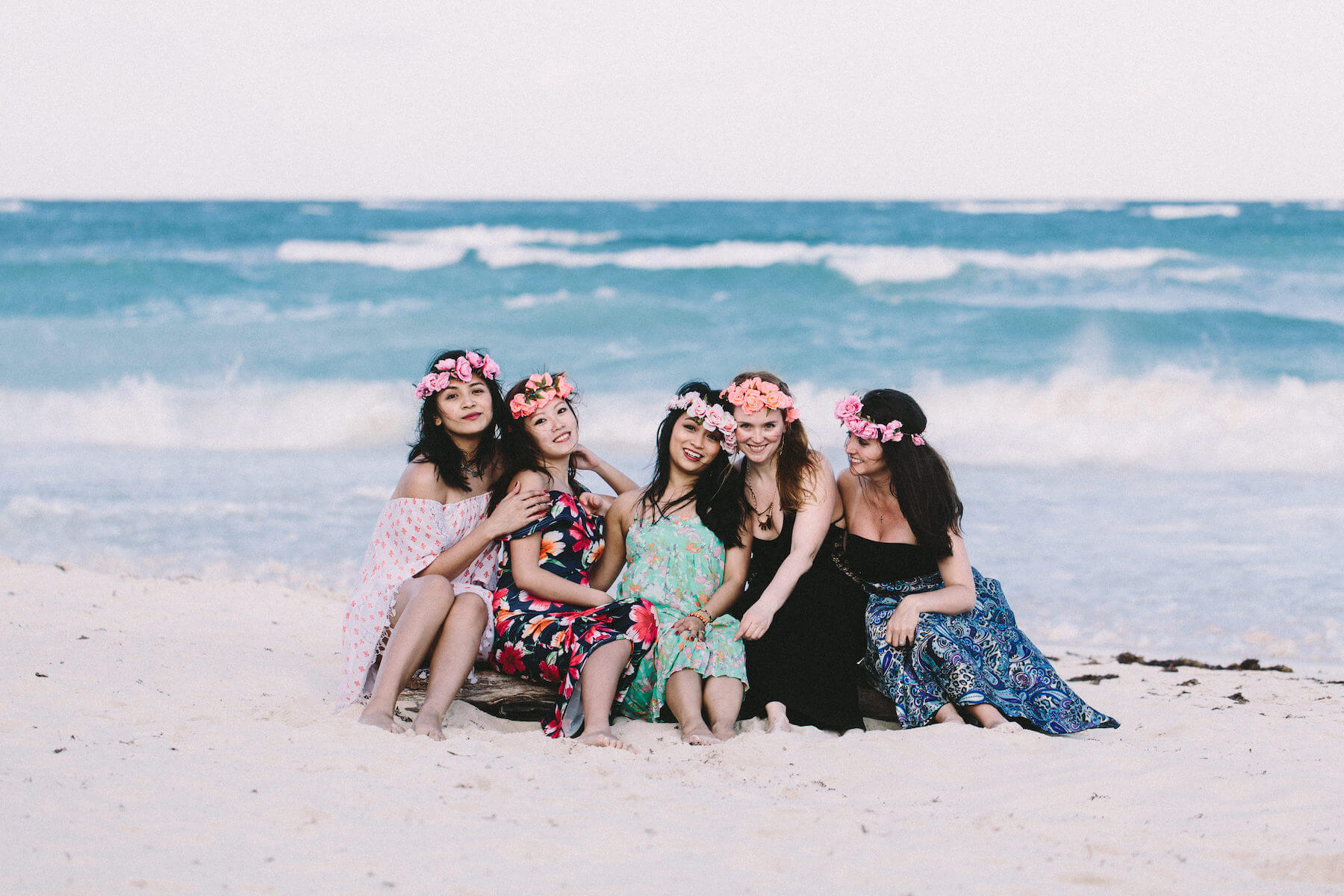girlfriends on a girls trip sitting on the beach in Tulum, Mexico
