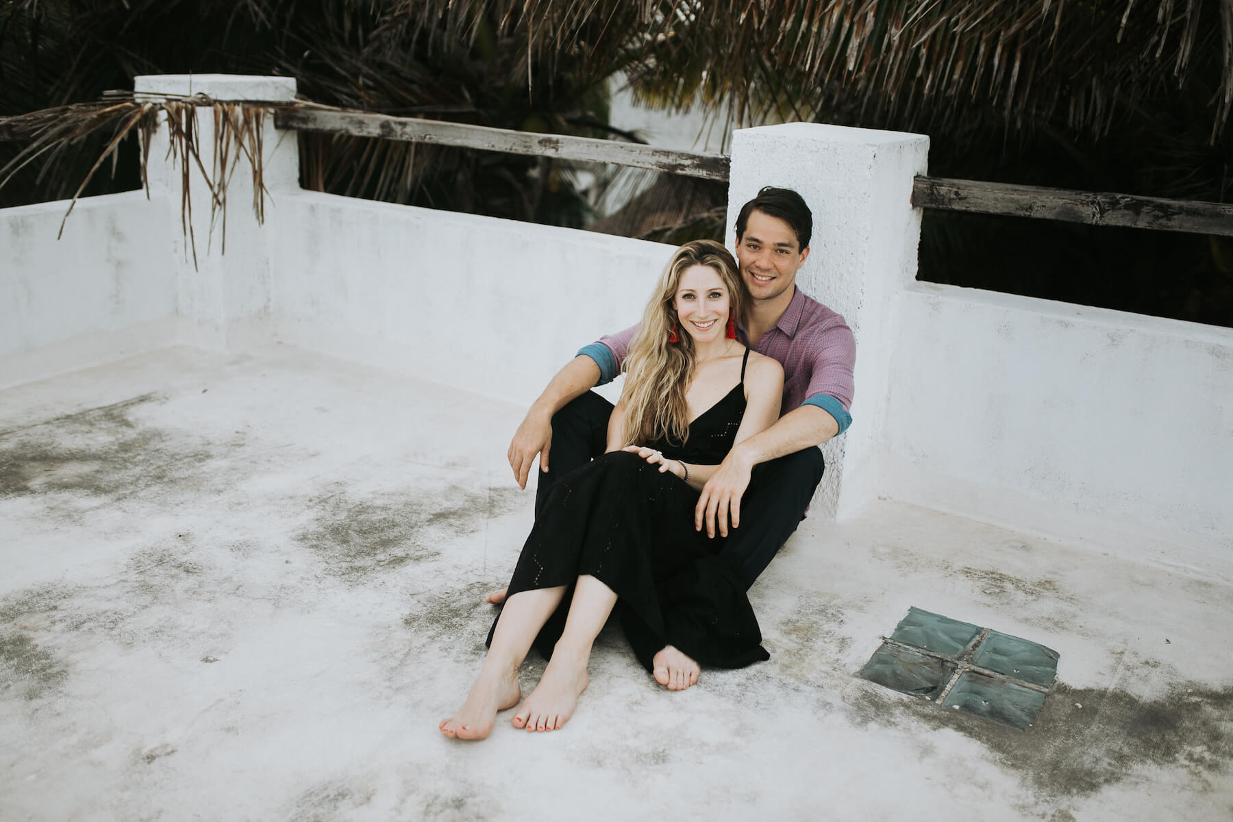 couple sitting down smiling in Tulum, Mexico