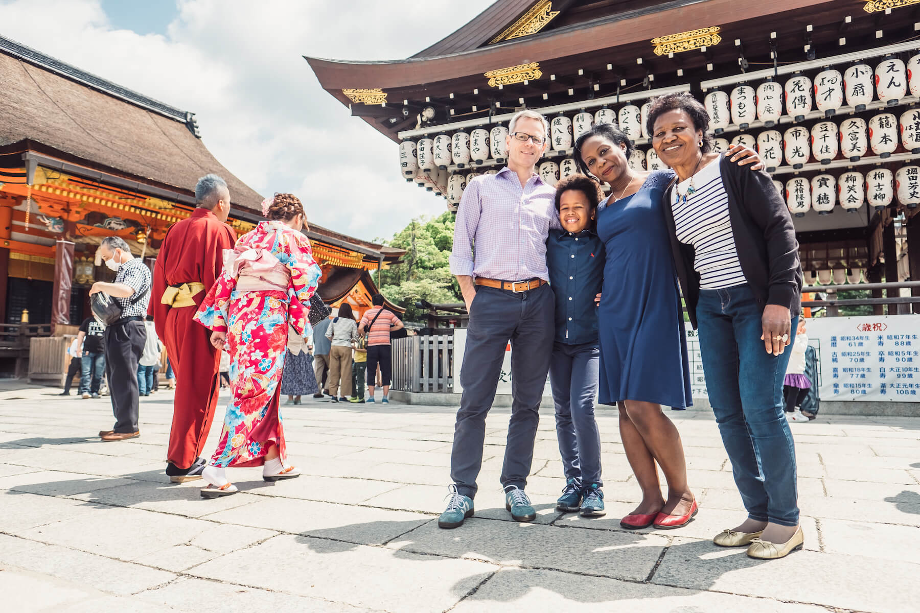 family standing in front of a shrine in Kyoto, Japan