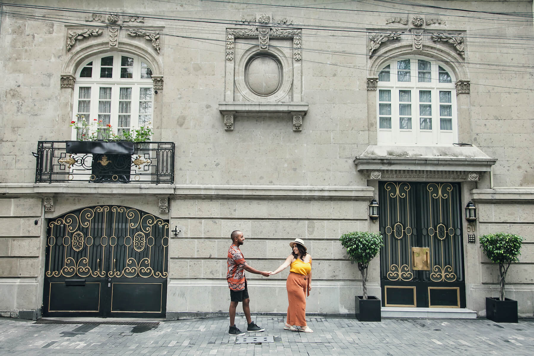 couple being plyaful holding hands walking in Mexico, City