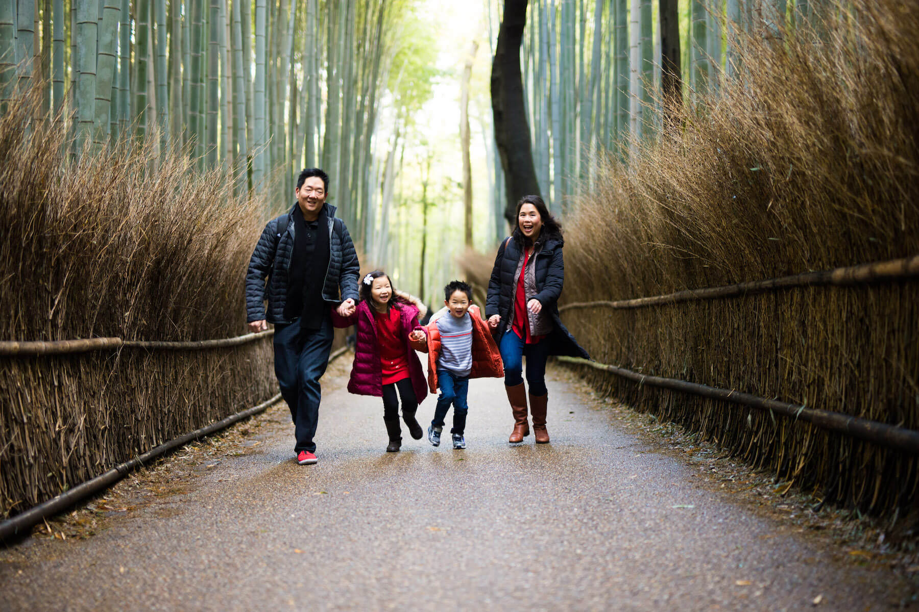family running in bamboo forest Kyoto Japan