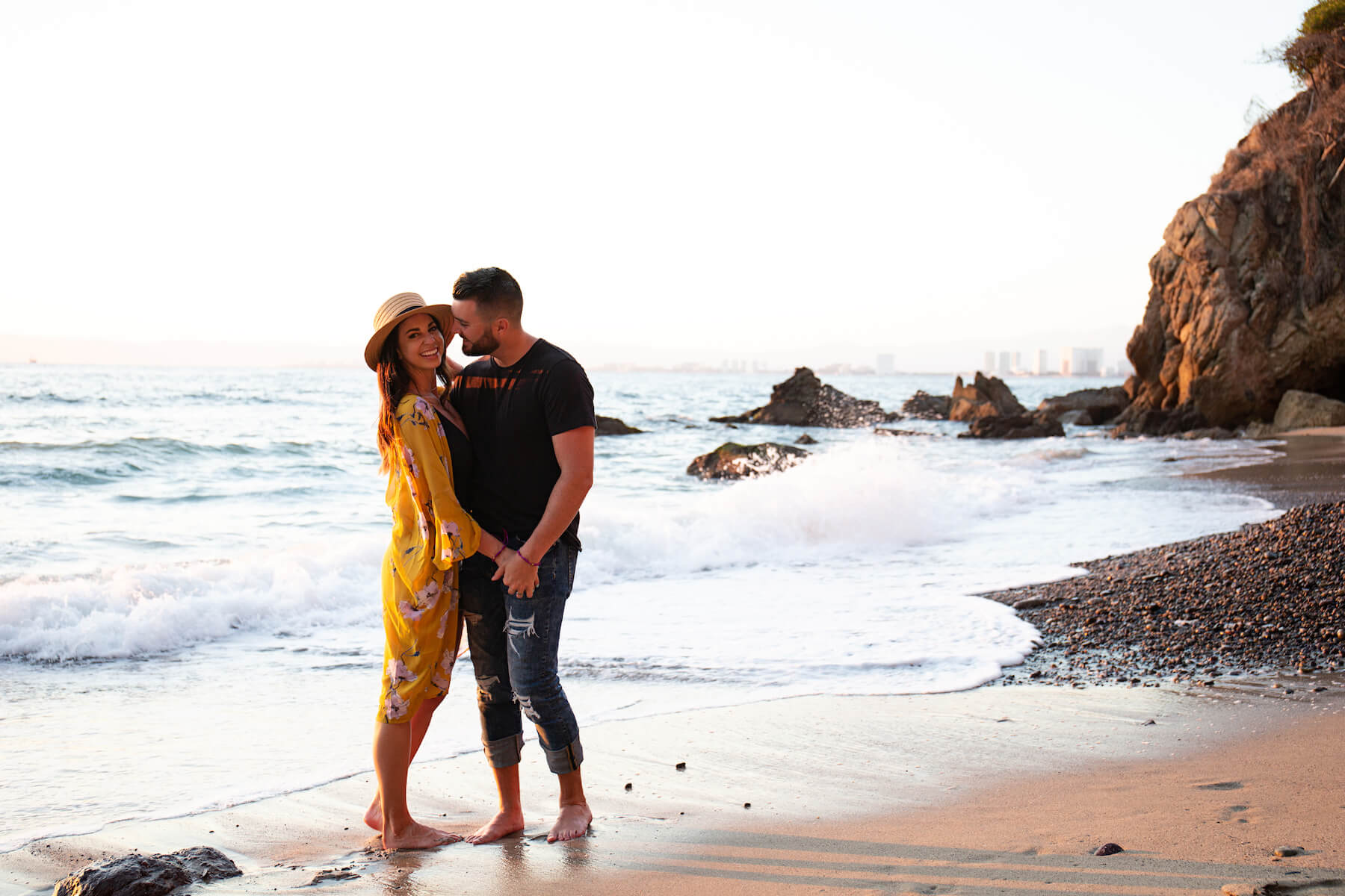 Couple holding each other on the beach watching the sunset in Puerto Vallarta, Mexico