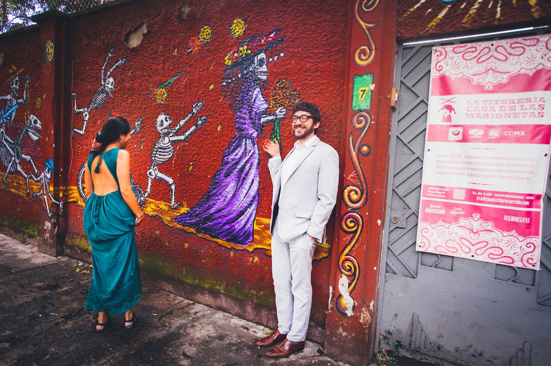 couple laughing and hanging out in front of colorful art in Mexico City, Mexico