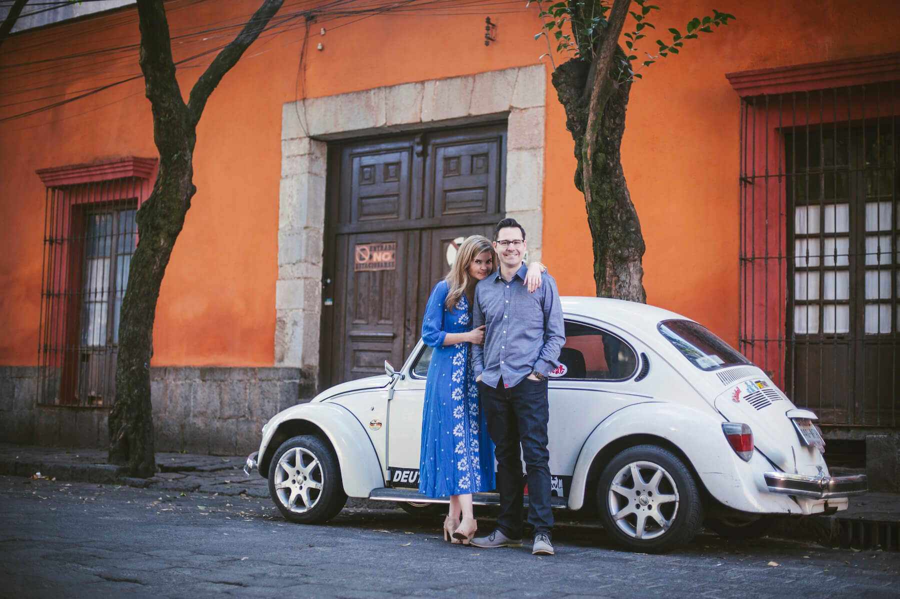couple hugging each other in front of car in Mexico City, Mexico