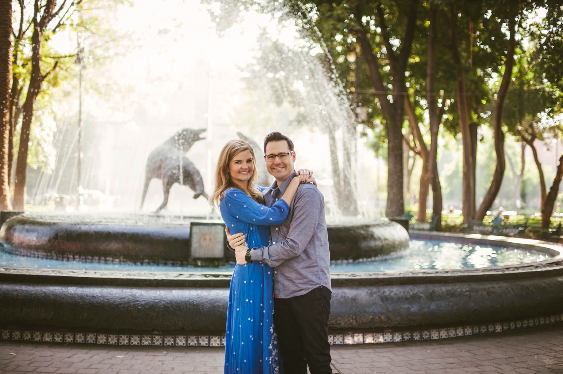 couple holding each other in front of a fountain in Mexico City, Mexico