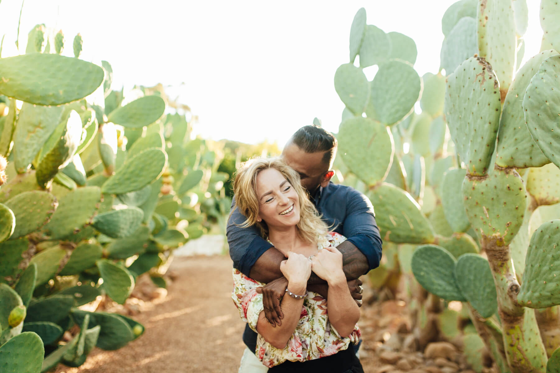 Couple laughing and hugging each other amongst cactus in Cape Town, South Africa