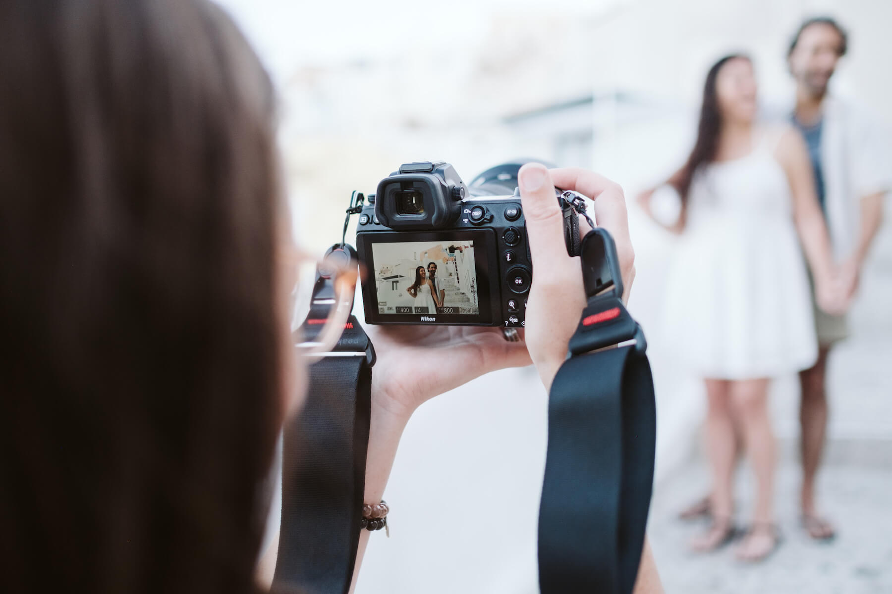 Photographer taking a photo of a couple in Santorini, Greece