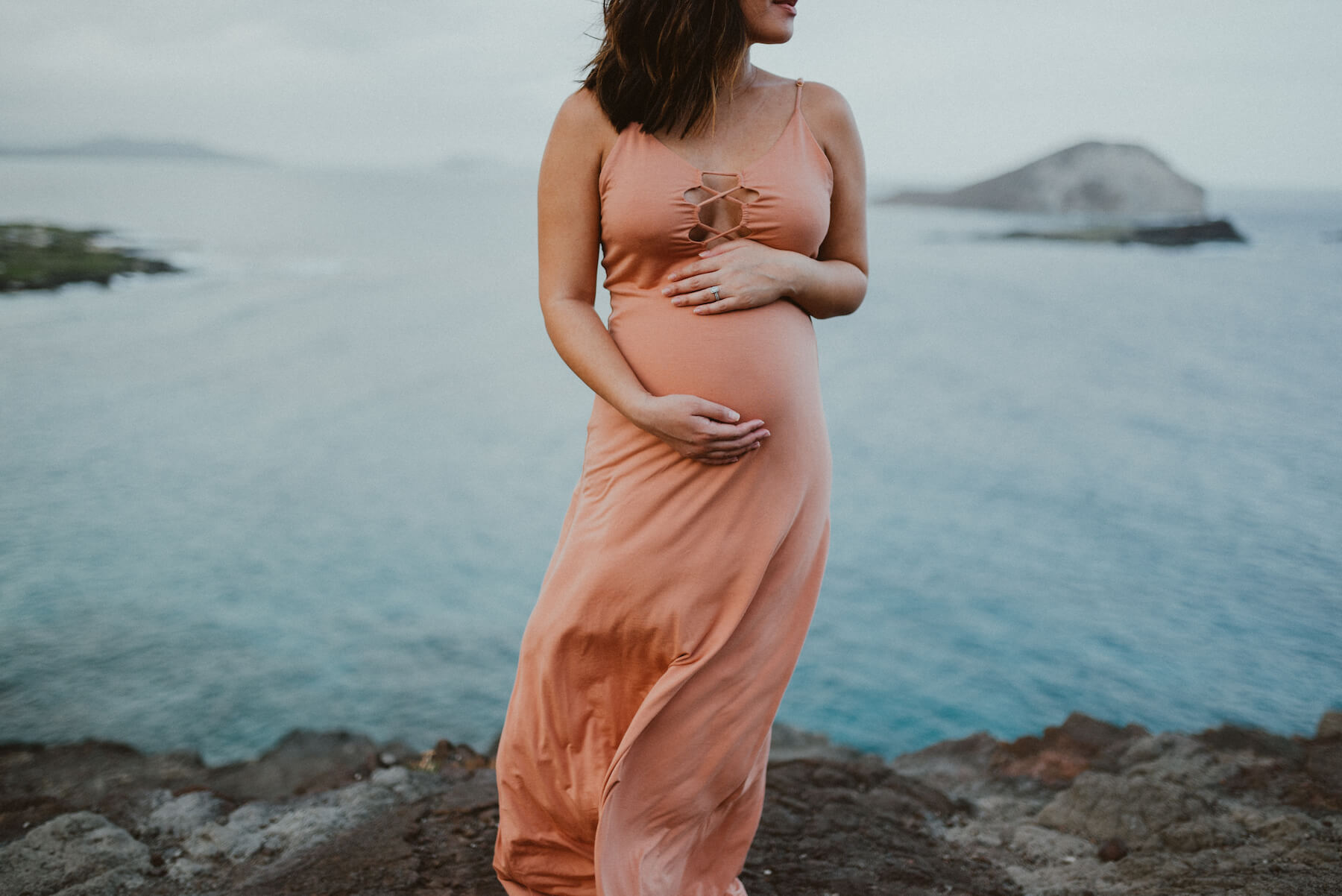 pregnant woman holding her stomach in Honolulu, Hawaii