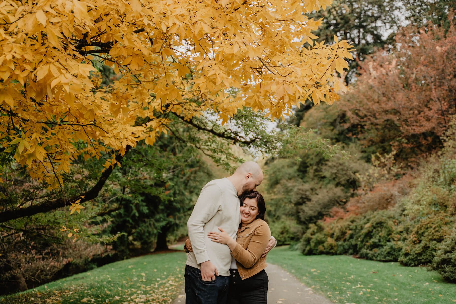 solo woman traveller on a pier looking through a viewfinder out into the ocean in Seattle, Washington