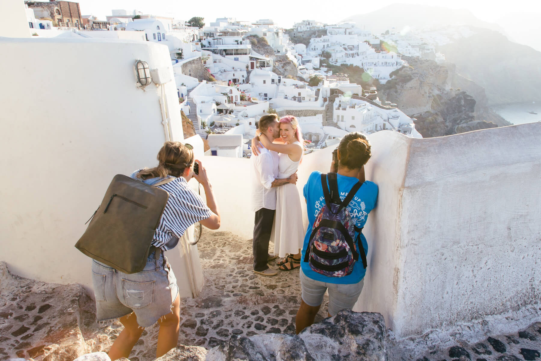 Photographers taking a photo of a couple in Santorini, Greece