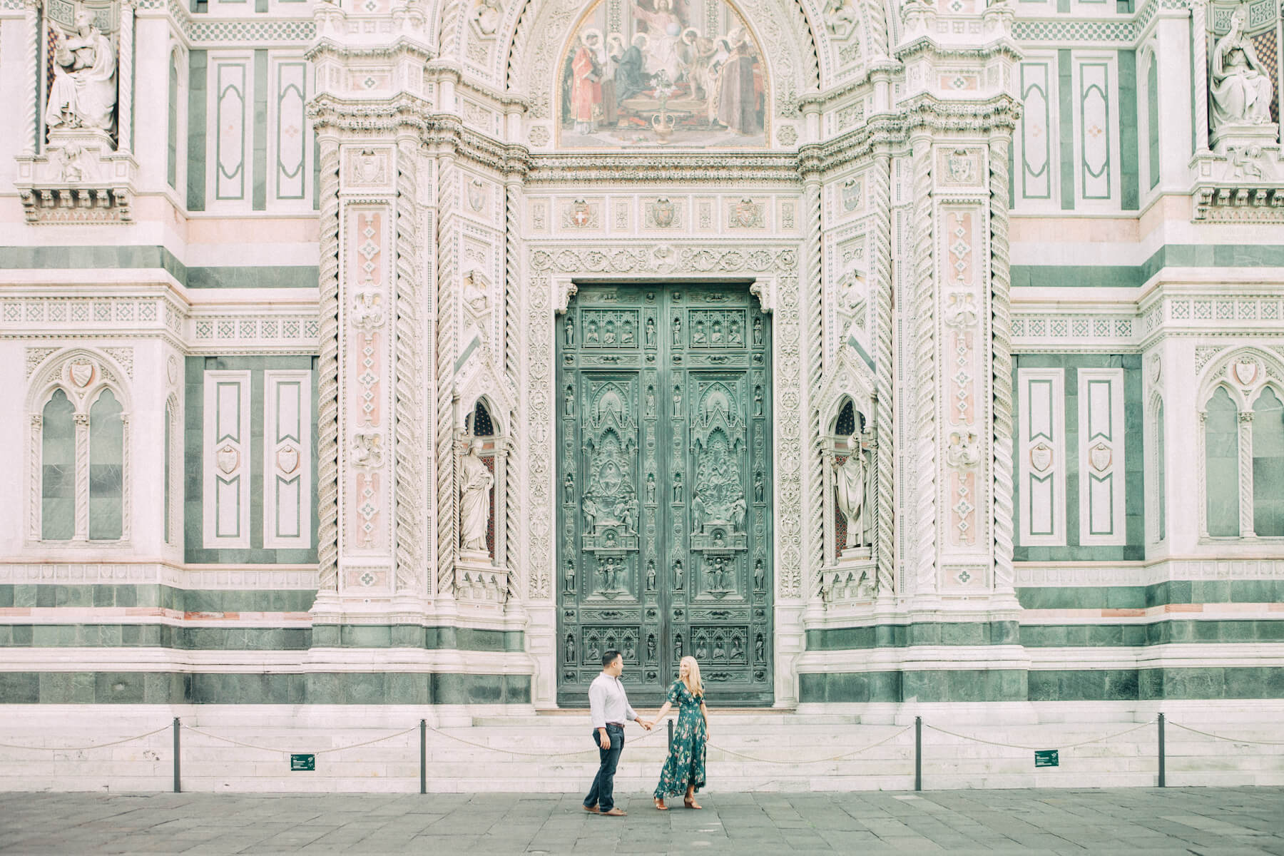 couple walking in front of the Duomo church in Florence, Italy