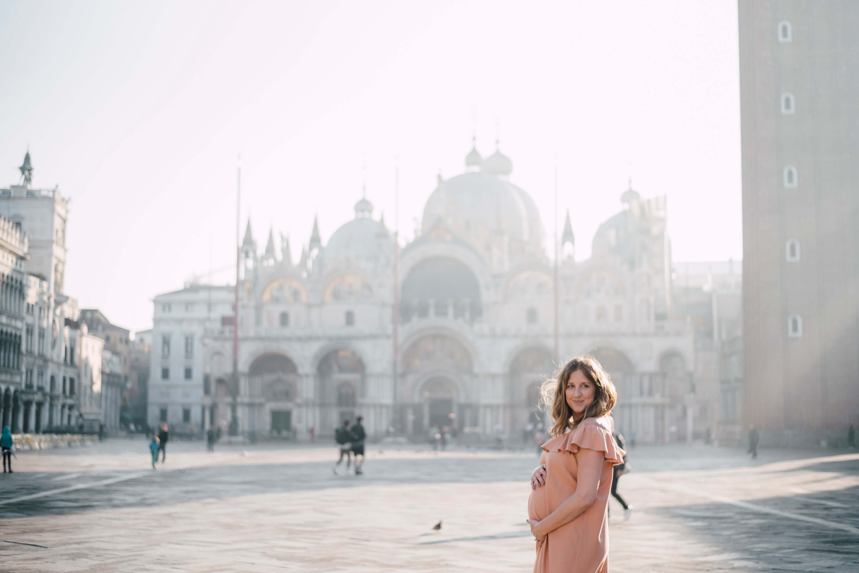 woman pregnant holding her belly in Venice, Italy