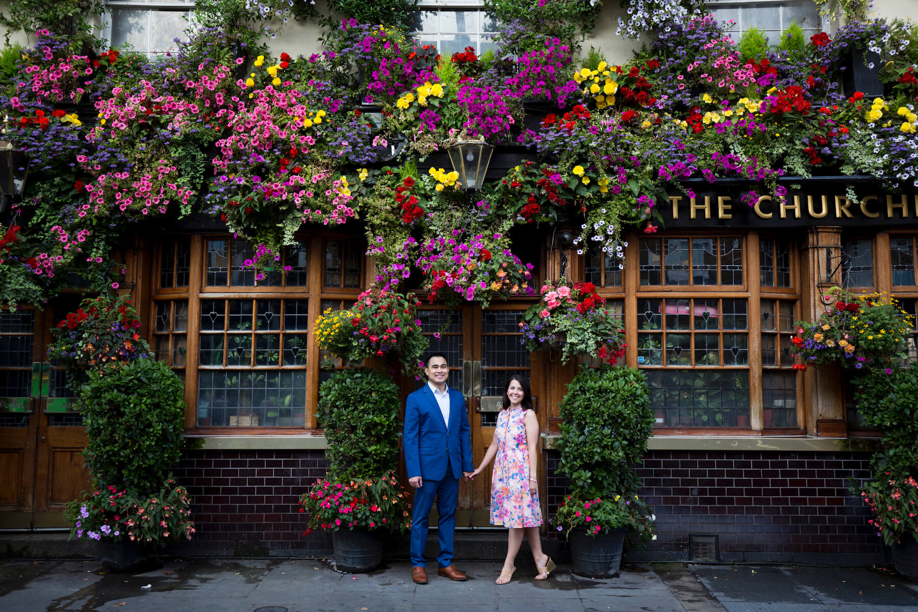 couples trip in front of a pub in London, England